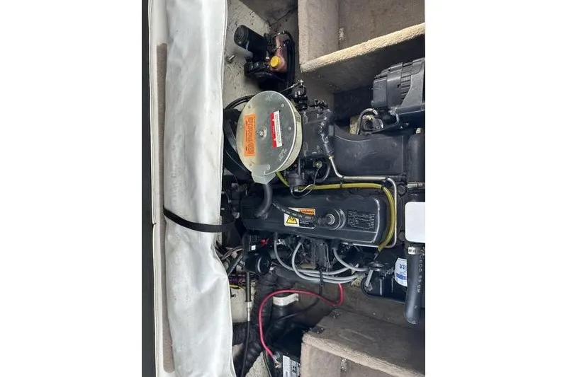 Slide: The Image of Engine compartment of a 2000 Ebbtide Campione 182 boat, showing detailed components. - 12