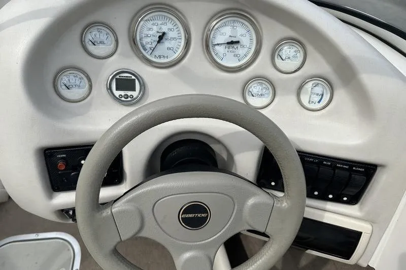 Slide: The Image of Dashboard of a 2000 Ebbtide Campione 182 boat with gauges and steering wheel. - 14