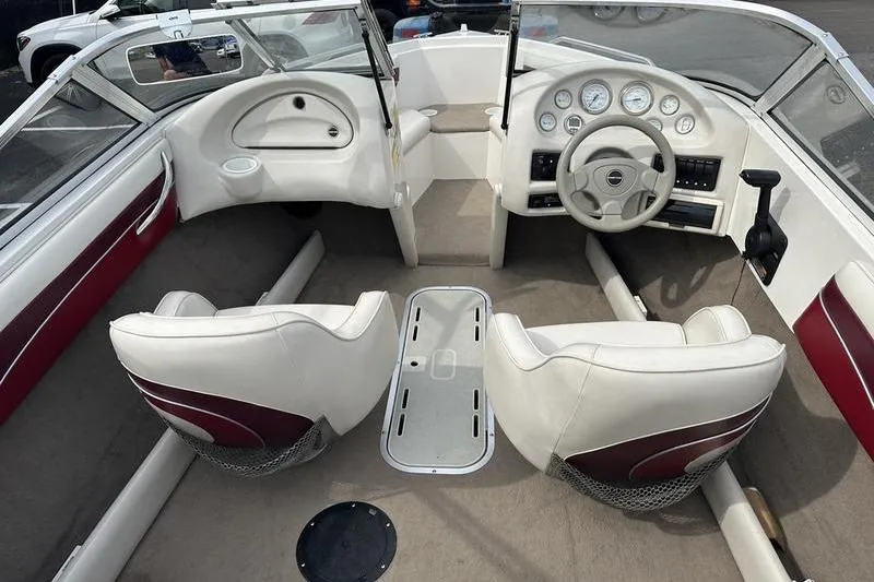 Slide: The Image of Interior of a 2000 Ebbtide Campione 182 boat with white and maroon seating. - 15