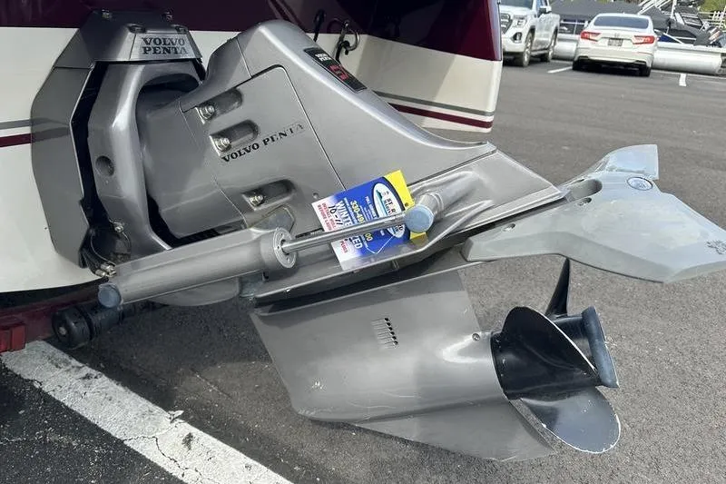Slide: The Image of Volvo Penta outboard motor on 2000 Ebbtide Campione 182 boat in parking lot. - 4