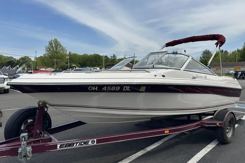 Slide: The Image of 2000 Ebbtide Campione 182 boat on trailer, parked outdoors under clear sky. - 5