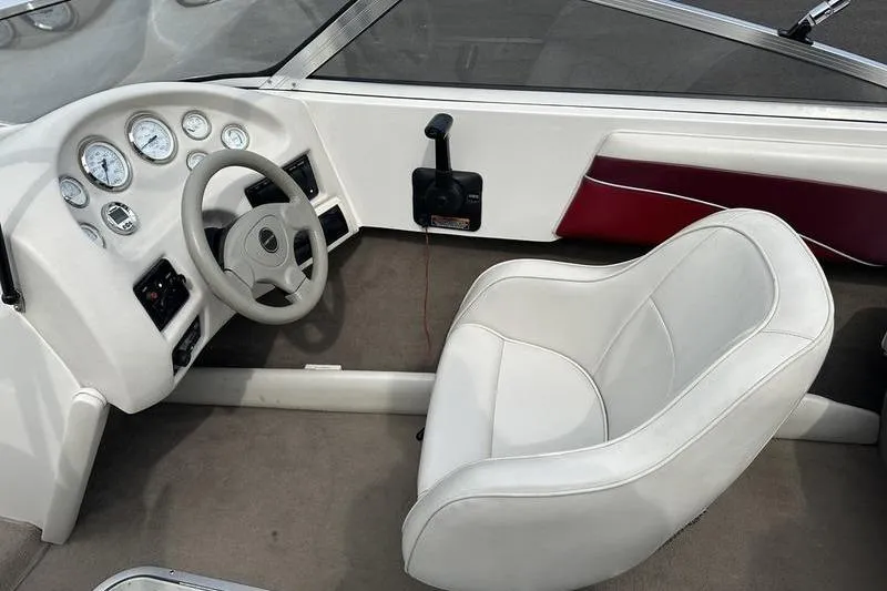 Slide: The Image of Interior of a 2000 Ebbtide Campione 182 boat, featuring steering wheel and gauges. - 7