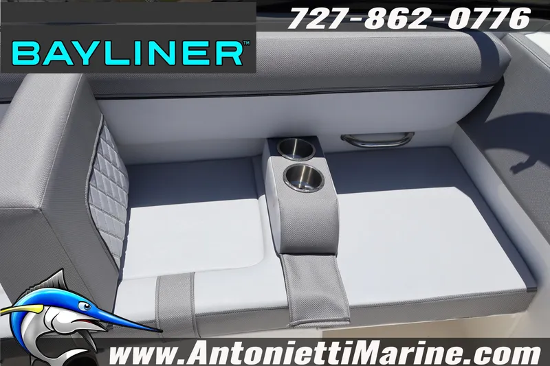 Slide: The Image of 2026 Bayliner D20 boat seating with cup holders, featuring gray upholstery. - 16