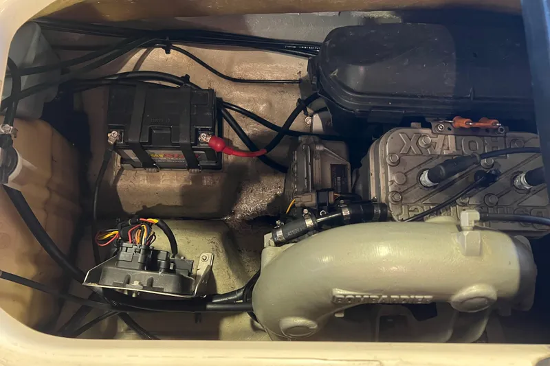 Slide: The Image of 2001 Sea-Doo GTI engine compartment showing battery and mechanical components. - 10