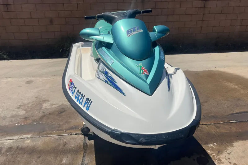 Slide: The Image of 2001 Sea-Doo GTI jet ski parked on concrete surface, showcasing sleek design and vibrant colors. - 4