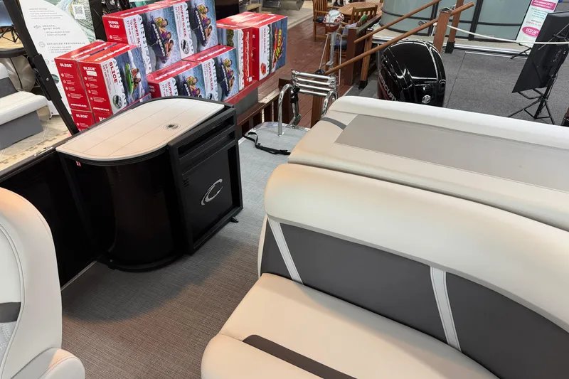 Slide: The Image of Interior of 2025 Crest Classic 200 boat with seating and storage, displayed in showroom. - 10