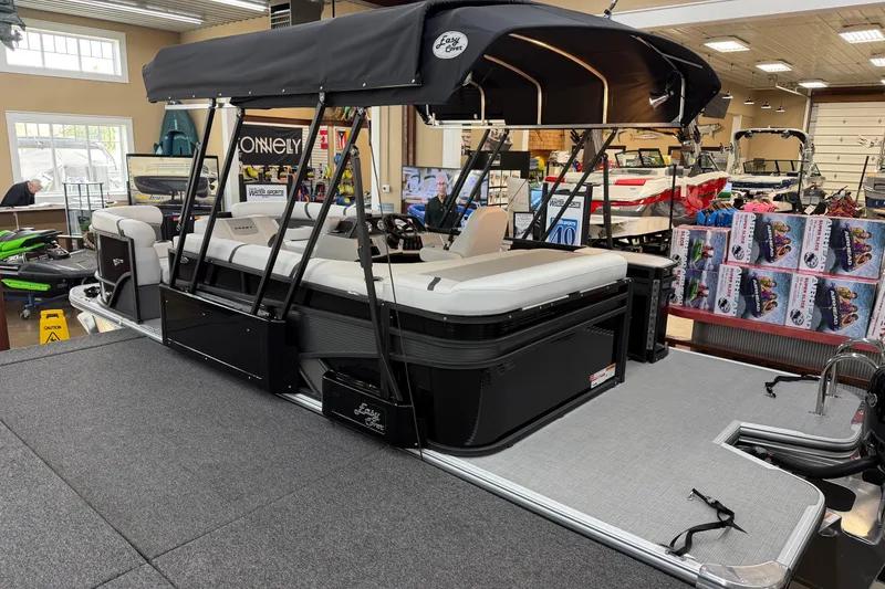 Slide: The Image of 2025 Crest Classic 200 pontoon boat with canopy in showroom setting. - 11