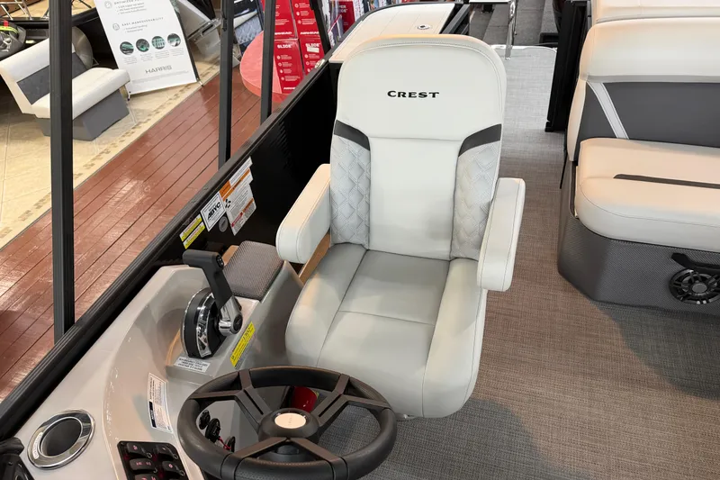 Slide: The Image of Captain's chair in 2025 Crest Classic 200 pontoon boat, featuring sleek design and modern controls. - 6