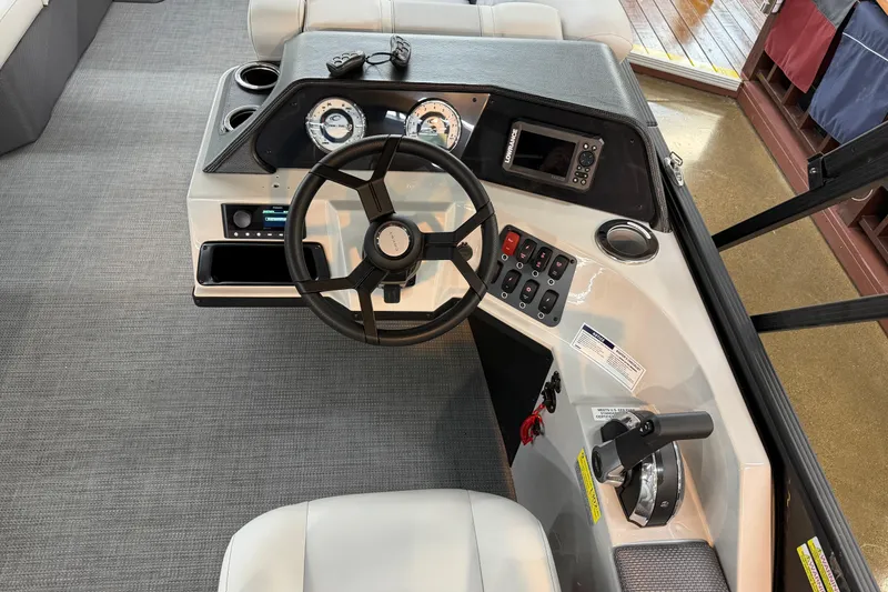 Slide: The Image of 2025 Crest Classic 200 boat dashboard with steering wheel, gauges, and control panel. - 7
