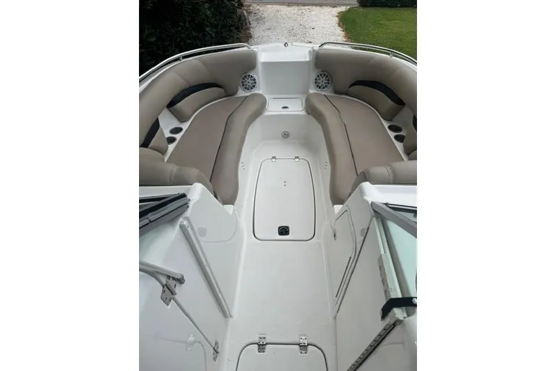 Slide: The Image of 2015 Hurricane SunDeck 2400 OB boat interior with beige seating and storage compartments. - 10