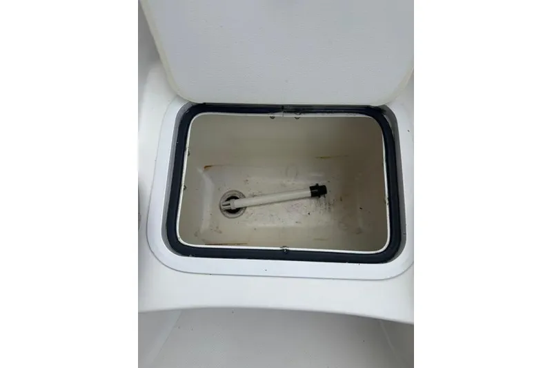Slide: The Image of Open storage compartment in 2015 Hurricane SunDeck 2400 OB boat. - 11
