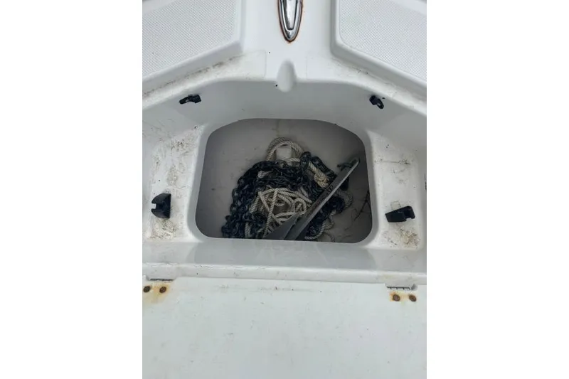 Slide: The Image of Anchor storage compartment on 2015 Hurricane SunDeck 2400 OB boat, containing chain and rope. - 12