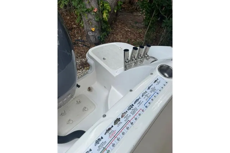 Slide: The Image of 2015 Hurricane SunDeck 2400 OB boat deck with fishing rod holders and fish measurement guide. - 20