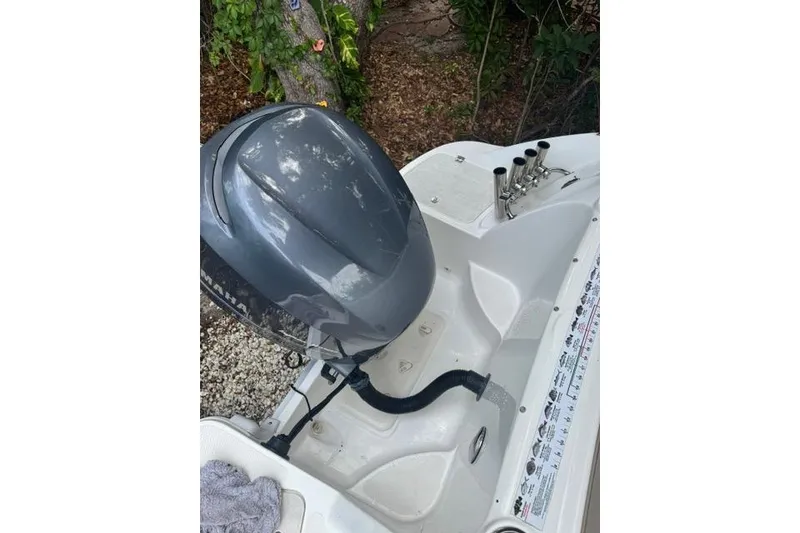 Slide: The Image of 2015 Hurricane SunDeck 2400 OB boat with outboard motor and rod holders. - 24