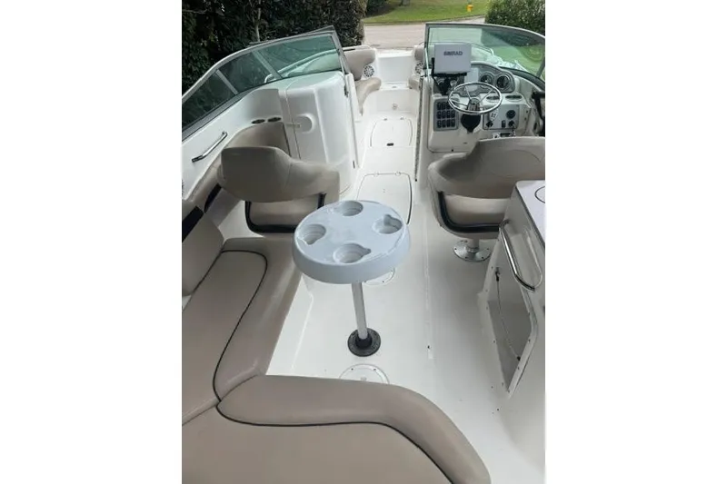 Slide: The Image of 2015 Hurricane SunDeck 2400 OB interior with seating and steering console. - 7