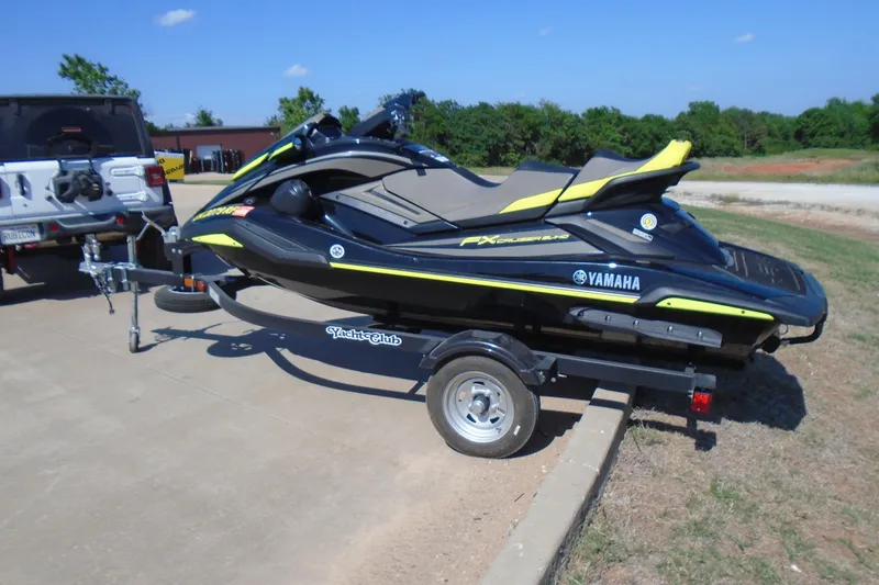 Slide: The Image of 2023 Yamaha WaveRunner FX Cruiser SVHO on trailer, parked outdoors on a sunny day. - 2