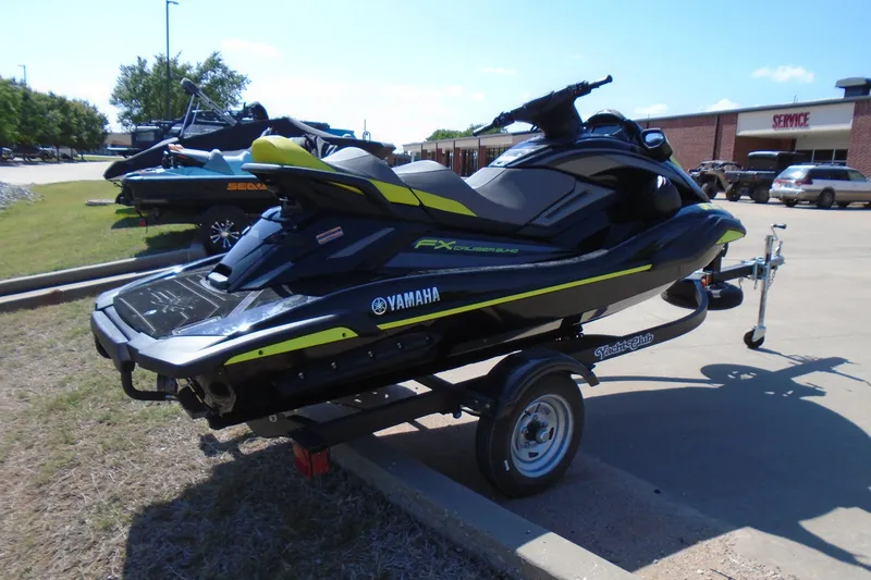 Slide: The Image of 2023 Yamaha WaveRunner FX Cruiser SVHO on trailer, parked outdoors in a service area. - 4