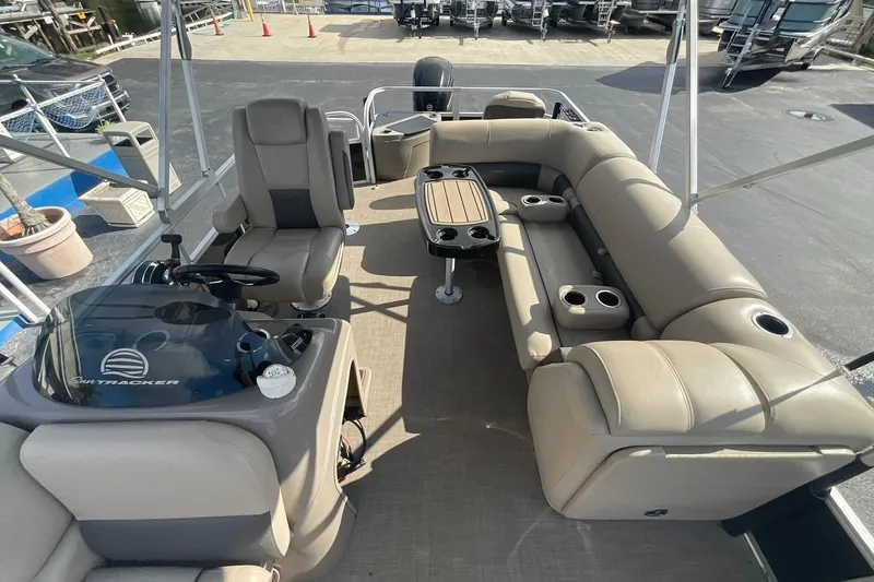 Slide: The Image of 2021 Sun Tracker Fishin' Barge 20 DLX interior with seating and steering console. - 11