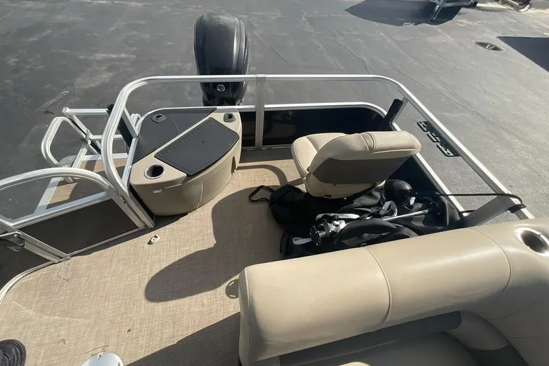 Slide: The Image of 2021 Sun Tracker Fishin' Barge 20 DLX interior with seating and fishing gear. - 12
