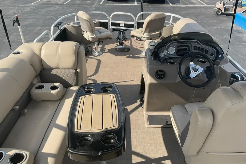 Slide: The Image of 2021 Sun Tracker Fishin' Barge 20 DLX interior with beige seating and steering console. - 15