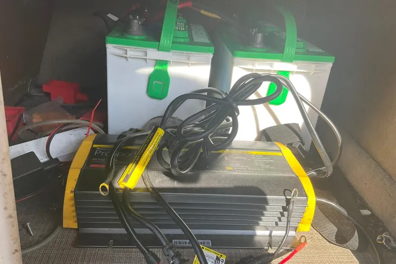 Slide: The Image of Battery charger and batteries inside a 2021 Sun Tracker Fishin' Barge 20 DLX boat. - 18
