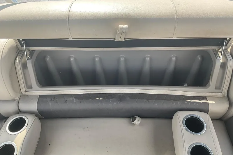 Slide: The Image of 2021 Sun Tracker Fishin' Barge 20 DLX storage compartment with cup holders and seating. - 19