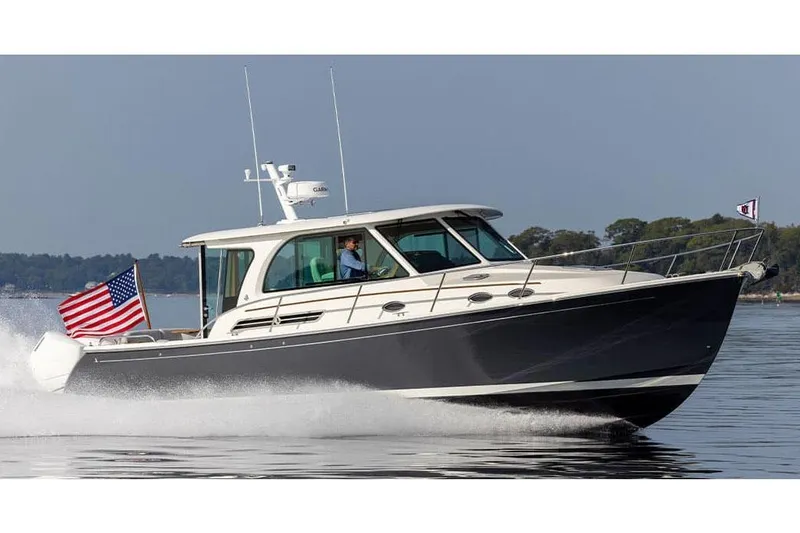 The Image of Manufacturer Provided Image: 2026 Back Cove 39O boat cruising on water with American flag. - 0