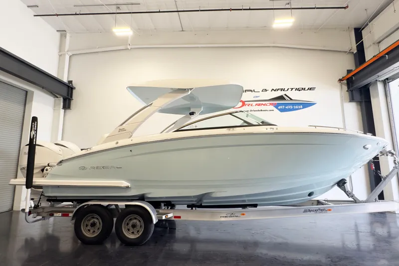 The Image of 2024 Regal LX9 boat on trailer in showroom, side view. - 0