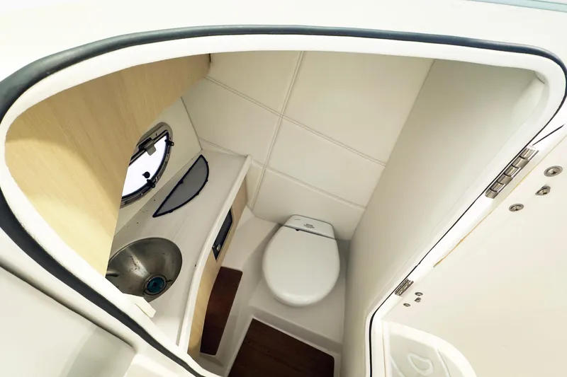 Slide: The Image of 2024 Regal LX9 boat interior bathroom with sink and toilet. - 10