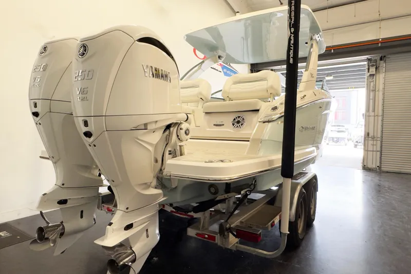 Slide: The Image of 2024 Regal LX9 boat with twin Yamaha 250 V6 engines in a garage setting. - 13