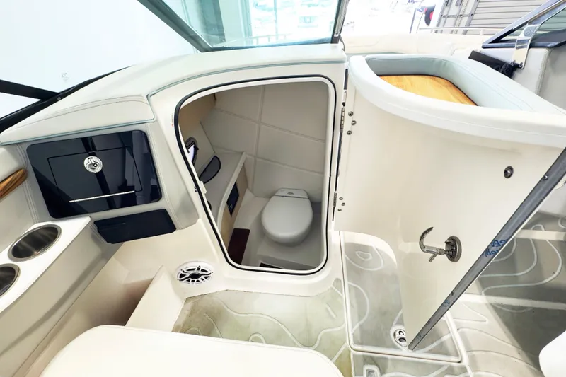 Slide: The Image of 2024 Regal LX9 boat interior featuring a compact, modern bathroom with sleek design elements. - 9