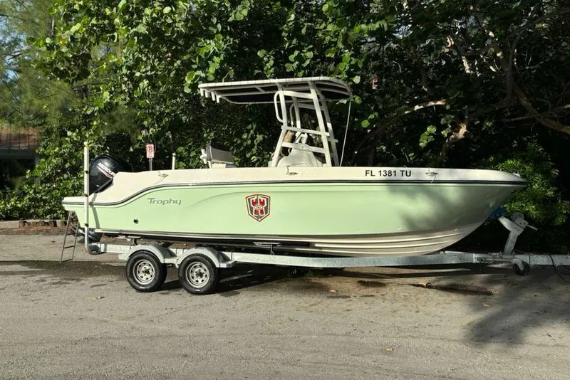 Slide: The Image of 2023 Bayliner Trophy T22CC boat on trailer, parked outdoors. - 4
