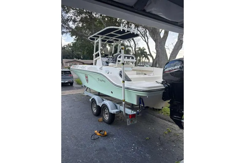 Slide: The Image of 2023 Bayliner Trophy T22CC boat on trailer with Mercury outboard motor. - 5