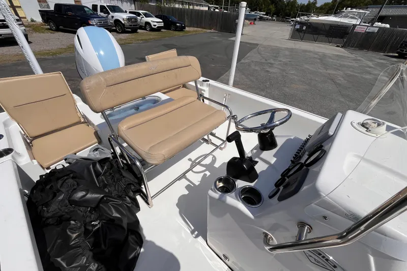 Slide: The Image of 2016 Tidewater 1910 Bay Max boat interior with beige seating and steering console. - 11