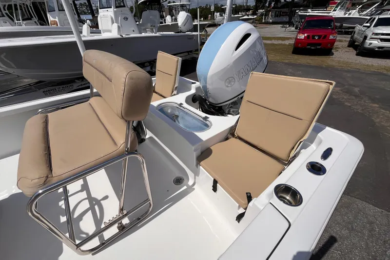 Slide: The Image of 2016 Tidewater 1910 Bay Max boat interior with beige seating and Yamaha outboard motor. - 6