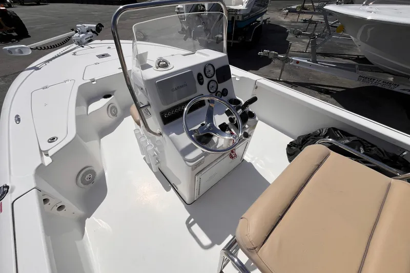 Slide: The Image of 2016 Tidewater 1910 Bay Max boat interior with steering console and beige seating. - 7