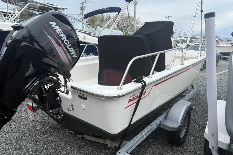 The Image of 2019 Boston Whaler 150 Montauk boat with Mercury engine on trailer. - 0