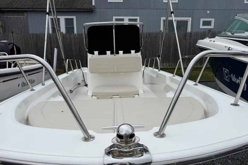 Slide: The Image of 2019 Boston Whaler 150 Montauk boat interior with seating and railing. - 4