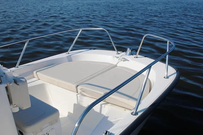 Slide: The Image of Manufacturer Provided Image: 2019 Boston Whaler 150 Montauk boat bow with cushioned seating on calm water. - 5