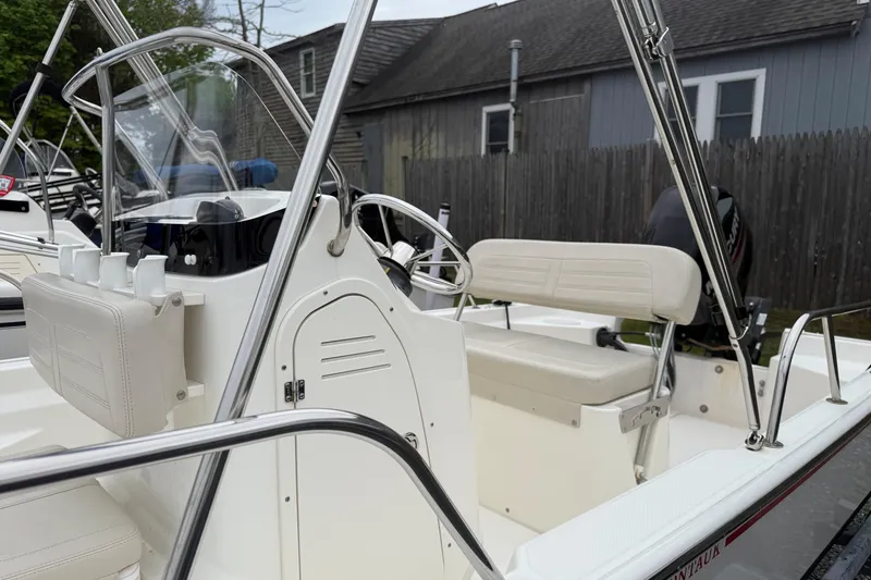 Slide: The Image of 2019 Boston Whaler 150 Montauk boat interior with steering console and seating. - 7