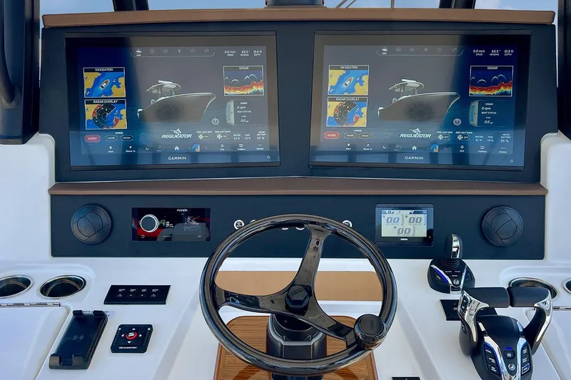 Slide: The Image of Control panel of 2027 Regulator 35 boat with dual Garmin displays and steering wheel. - 11