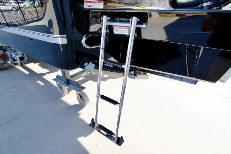Slide: The Image of Ladder on 2027 Regulator 35 boat, docked with trailer wheels visible. - 17