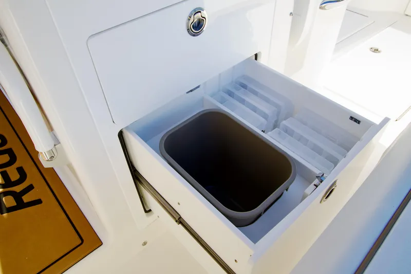 Slide: The Image of Storage compartment on 2027 Regulator 35 boat with integrated trash bin and organizer. - 20