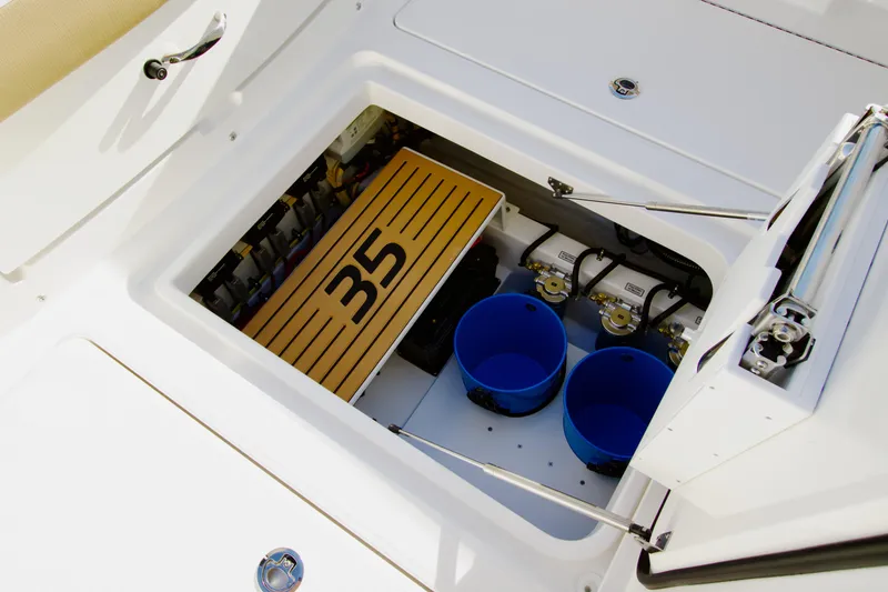 Slide: The Image of Open hatch of 2027 Regulator 35 boat showing storage compartment and equipment. - 21