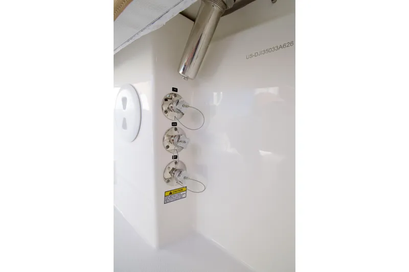 Slide: The Image of 2027 Regulator 35 boat fittings and caution label on white surface. - 22
