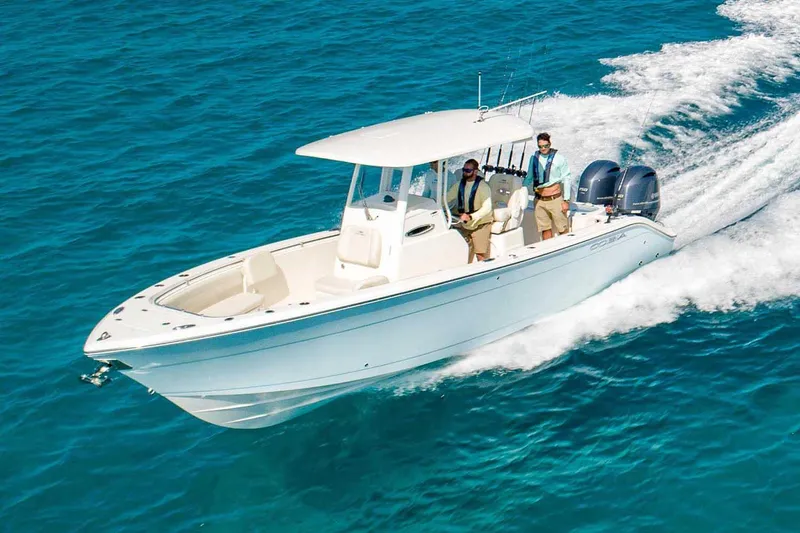 The Image of Manufacturer Provided Image: 2022 Cobia 262 Center Console boat cruising on clear blue water. - 0