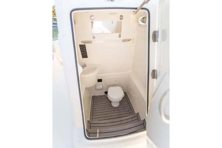 Slide: The Image of Manufacturer Provided Image: 2022 Cobia 262 Center Console boat interior bathroom with toilet and sink. - 11