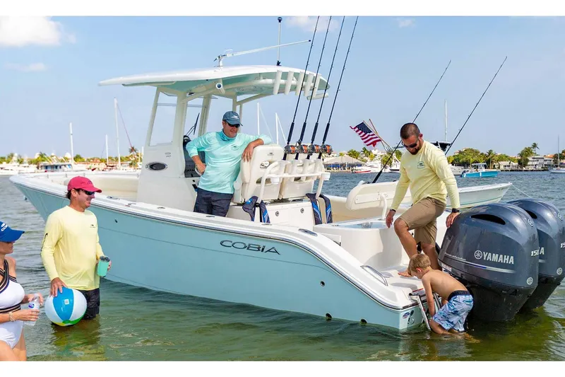 Slide: The Image of Manufacturer Provided Image: 2022 Cobia 262 Center Console boat with Yamaha engines in shallow water, people enjoying the day. - 3