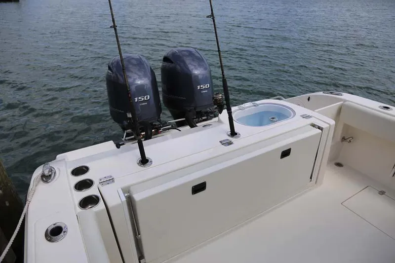 Slide: The Image of Manufacturer Provided Image: 2022 Cobia 262 Center Console boat with twin 150 HP engines on the water. - 8