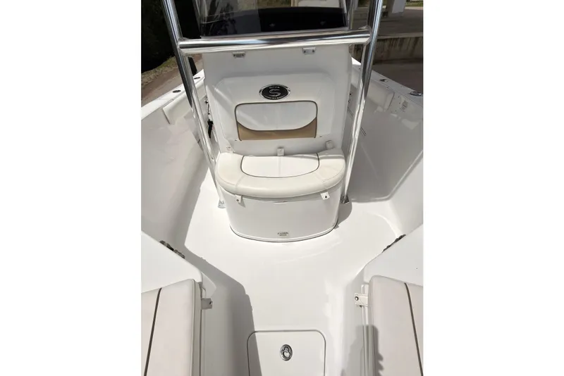 Slide: The Image of 2015 Sportsman Open 212 Center Console boat interior with cushioned seating and storage. - 10